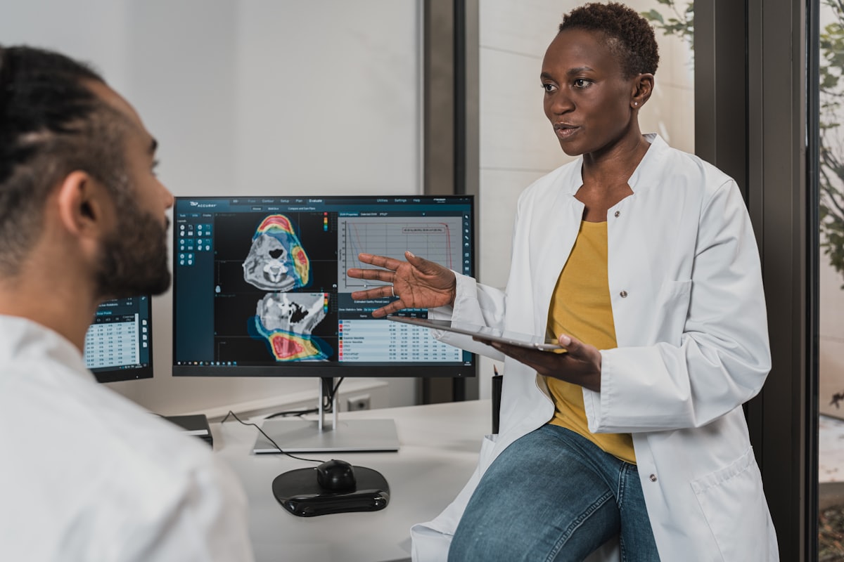 Two clinicians reviewing information at a workstation