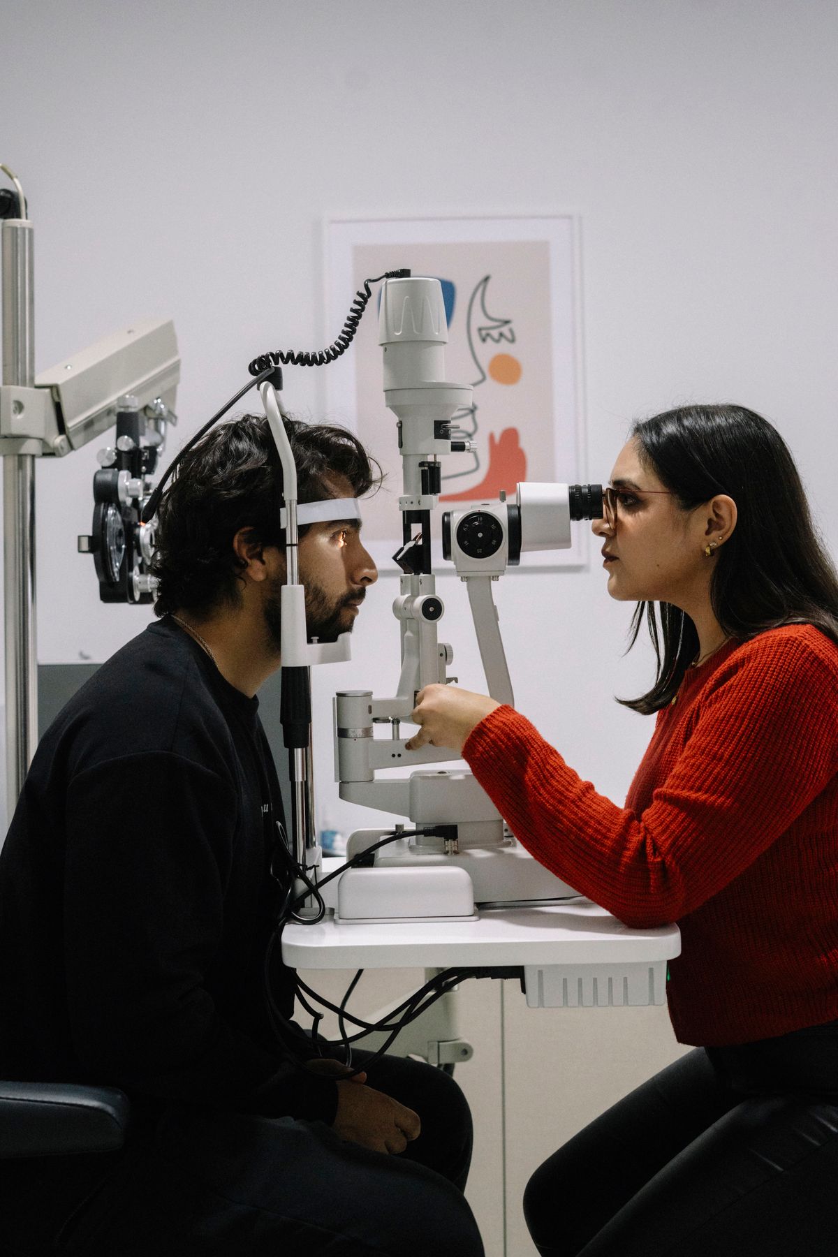 An optometrist performing an eye exam with modern equipment