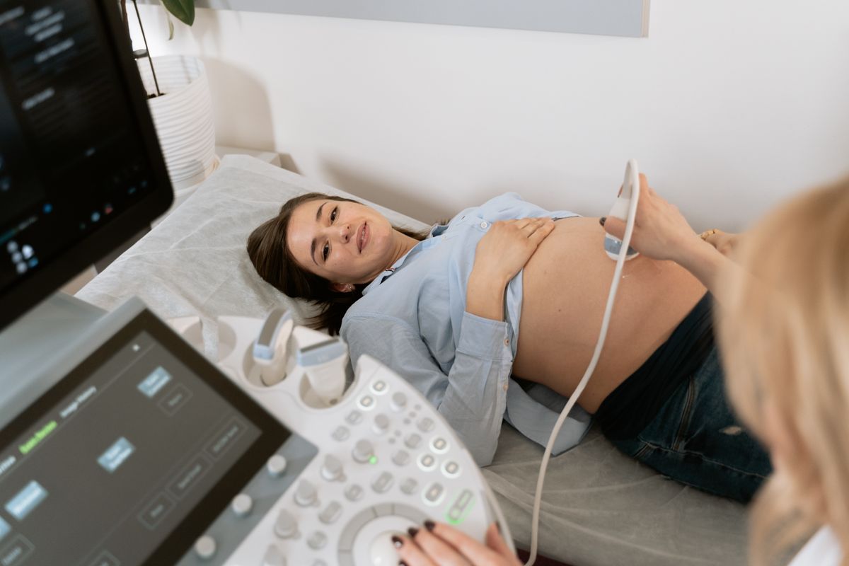 A smiling woman during an ultrasound scan at a fertility clinic