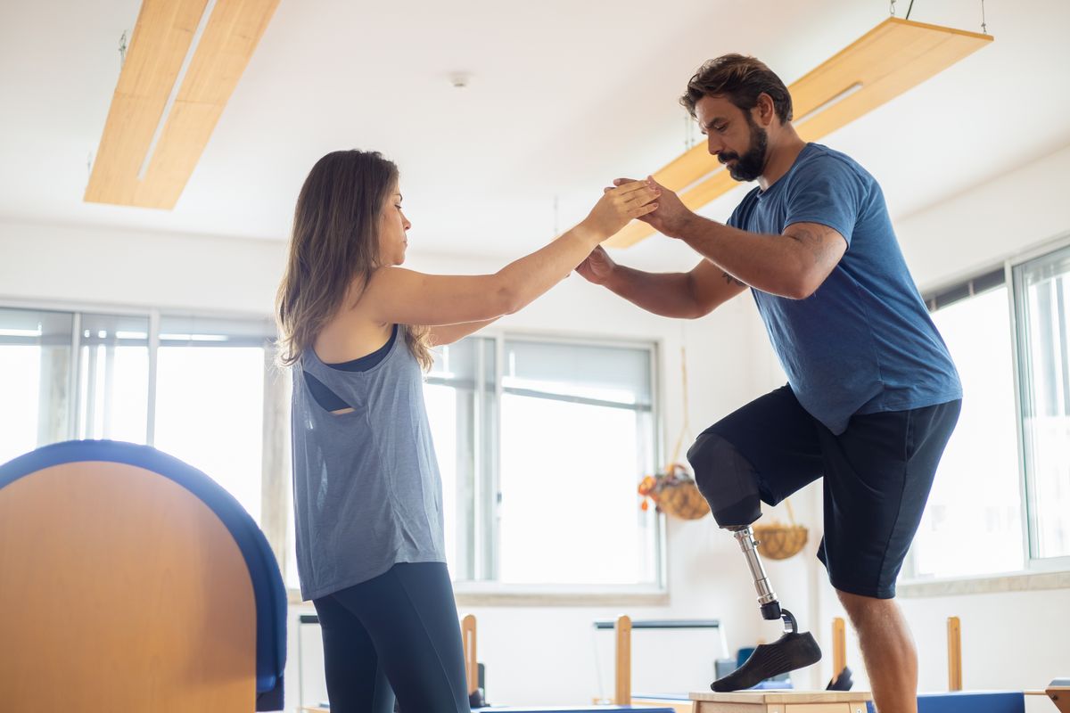 A physical therapist guiding a patient through a mobility exercise
